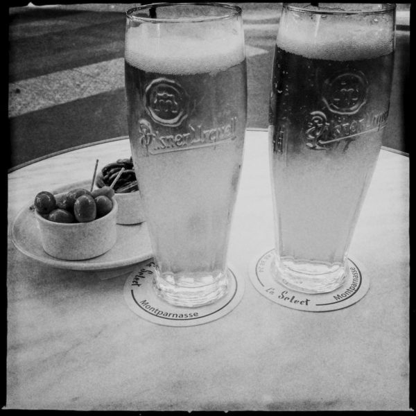Zwei Biere und Oliven stehen auf dem Tisch des Cafe Le Select in Paris