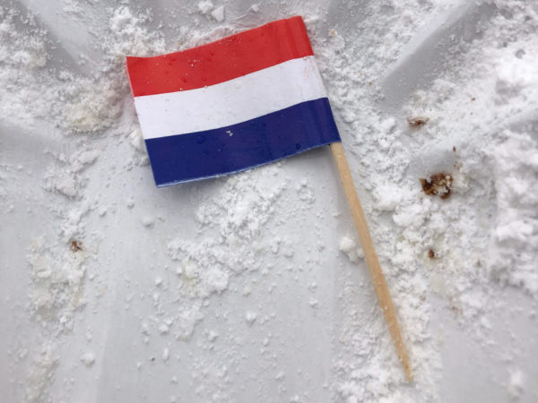 Niederländische Flagge in leer gegessener Poffertjesschale im Keukenhof