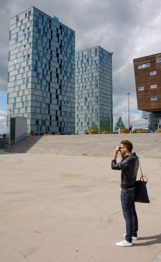 Mann fotografiert die Hochhäuser Side by Side in Almere