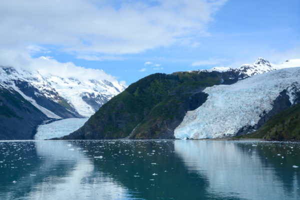 Landschaft mit Gletscher, grünem Felsen und schneebedeckten Bergen im Prinz-William-Sund in Alaska