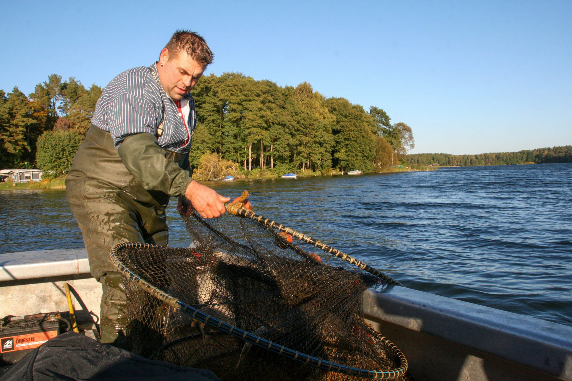 Fischer Gehrt mit Reuse auf einem Fluss in Mecklenburg