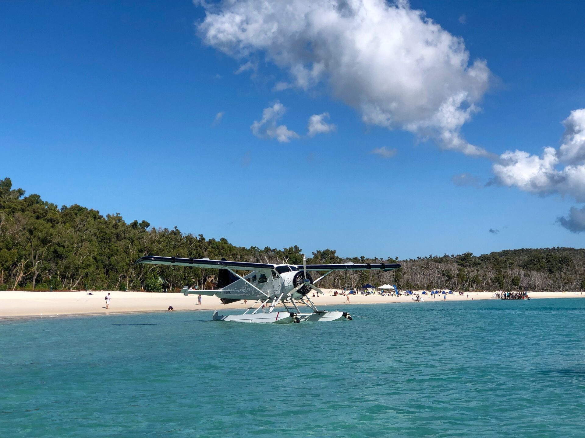 Wasserflugzeug am Strand von Whitehaven Beach mit vielen Badegästen der Whitsunday Islands