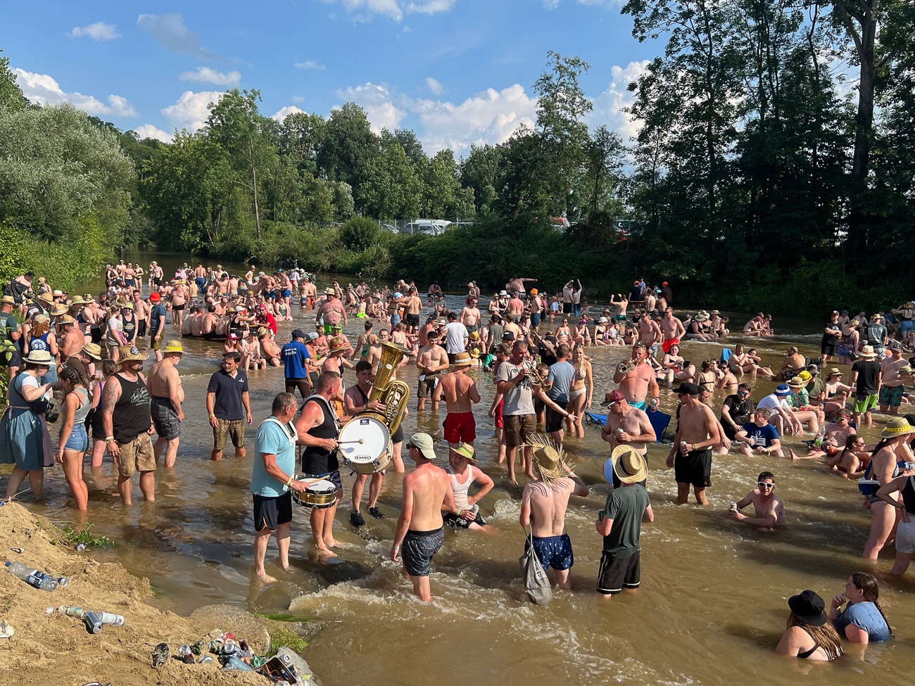 Massenbad im Fluss Antiesen mit Blasmusikern