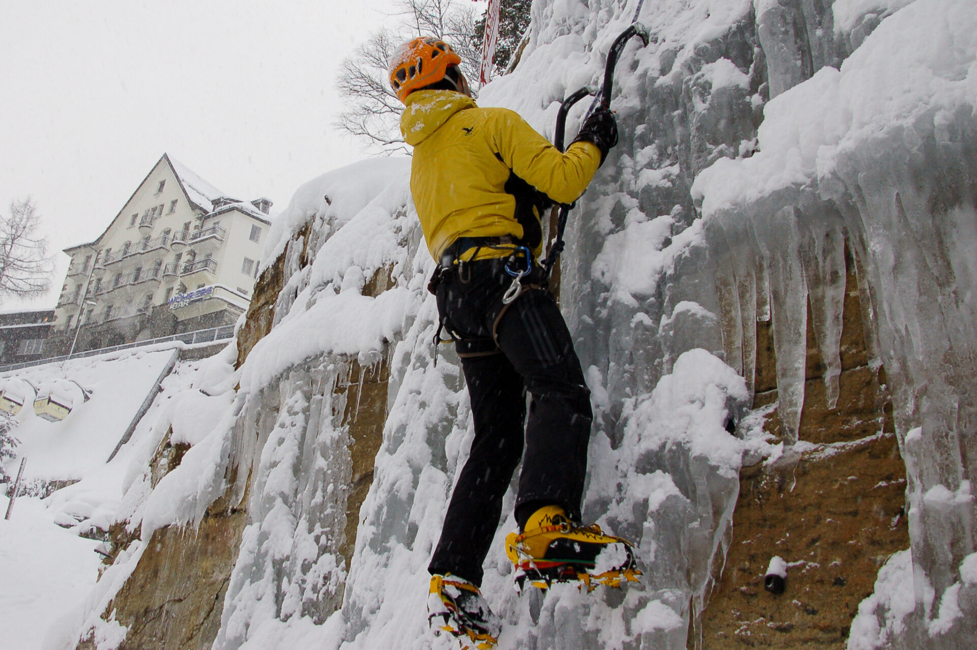 Eiskletterer in einer zugefrorenen Wand in Gastein mit Steigeisen
